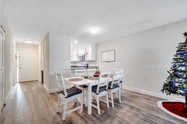 dining space with light hardwood / wood-style flooring