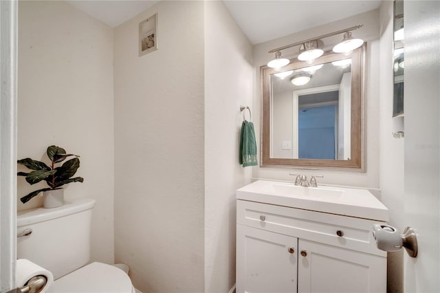 bathroom featuring vanity and toilet