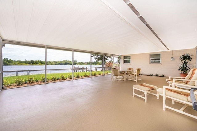 sunroom / solarium featuring a water view