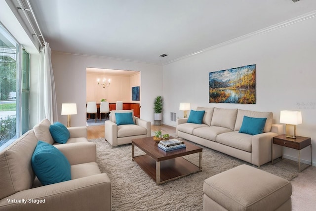 living room featuring crown molding and a notable chandelier