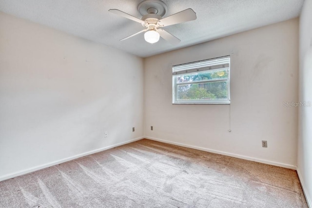 spare room with carpet and ceiling fan