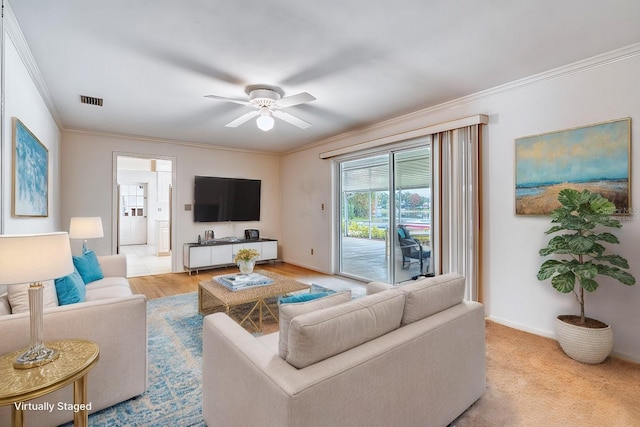 living room featuring ceiling fan and ornamental molding