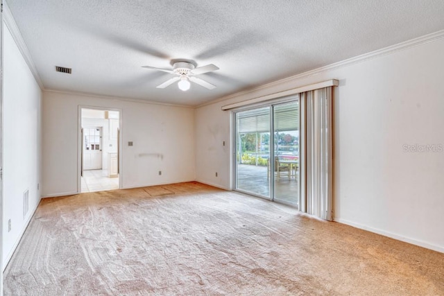 empty room featuring a textured ceiling, ceiling fan, ornamental molding, and light carpet