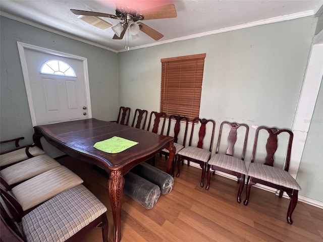 dining room with crown molding, light hardwood / wood-style flooring, and ceiling fan