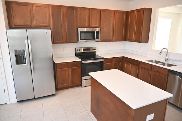 kitchen featuring light tile patterned flooring, stainless steel appliances, and sink