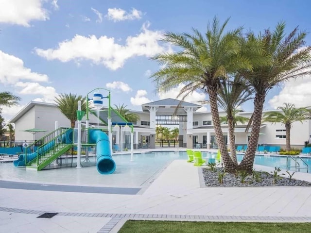 view of swimming pool featuring a playground