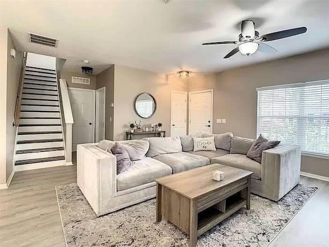 living room featuring ceiling fan and wood-type flooring