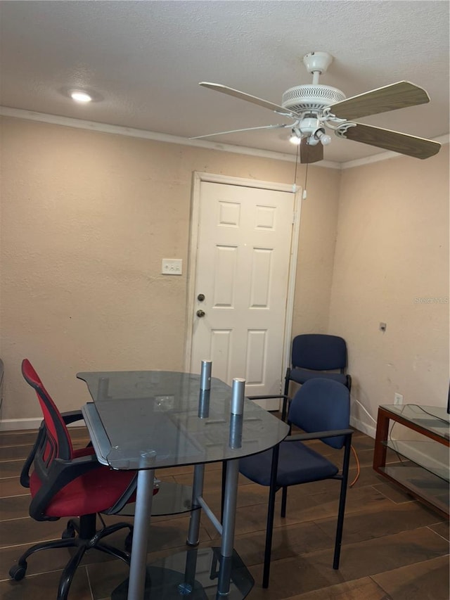 dining room featuring ceiling fan, dark wood-type flooring, and crown molding