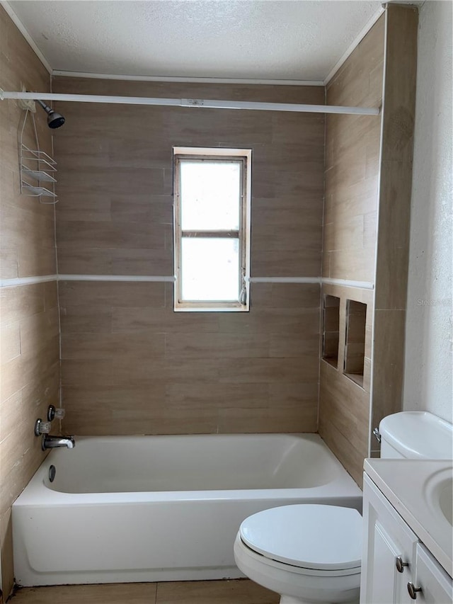 full bathroom with toilet, a textured ceiling, tiled shower / bath combo, and vanity