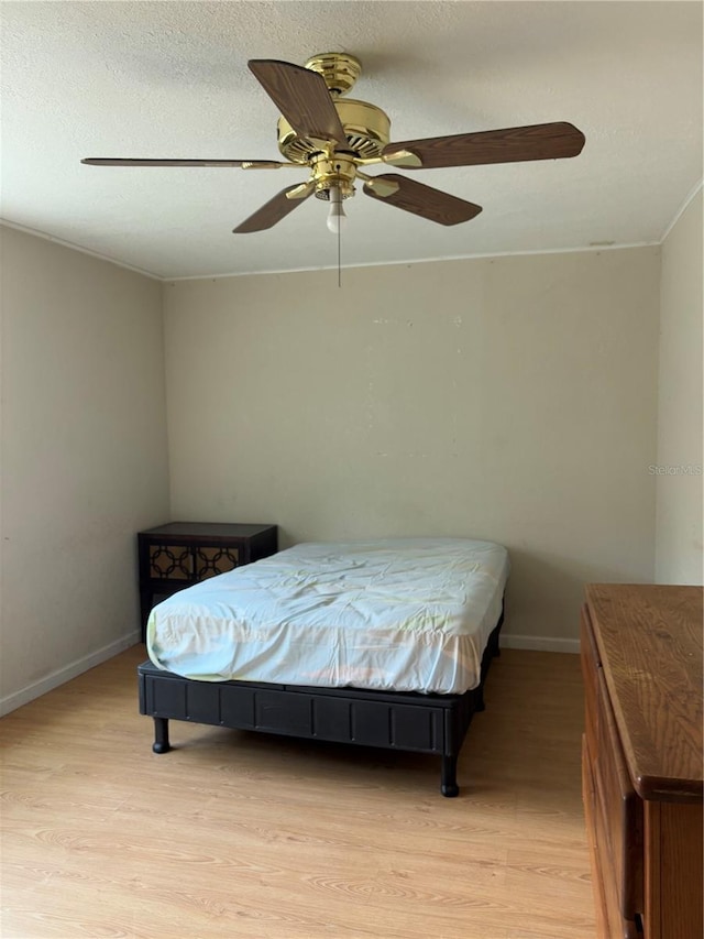 bedroom with ceiling fan and light wood-type flooring