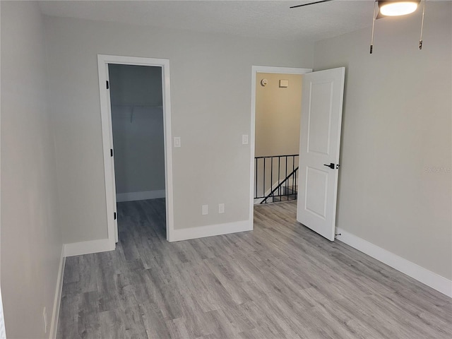 spare room featuring ceiling fan and light hardwood / wood-style floors