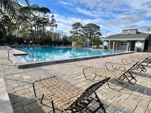 view of swimming pool with a patio