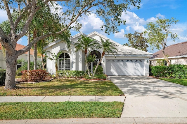 view of front of property featuring a garage and a front yard