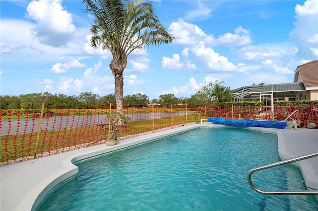 view of swimming pool featuring fence and a fenced in pool