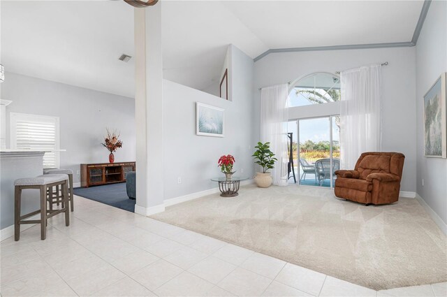 living area featuring high vaulted ceiling, tile patterned flooring, carpet flooring, visible vents, and baseboards