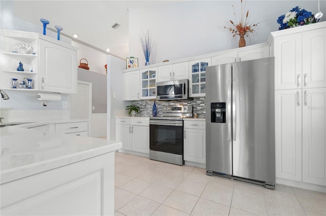 kitchen with stainless steel appliances, light countertops, visible vents, and a sink