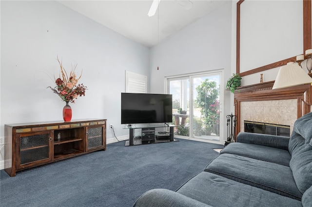 carpeted living area featuring high vaulted ceiling, a tiled fireplace, a ceiling fan, and baseboards