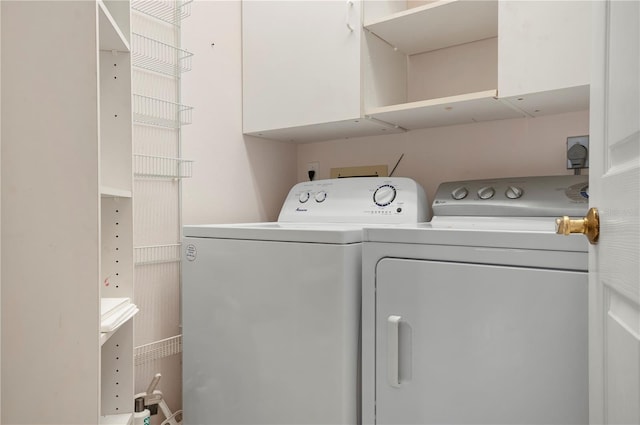 clothes washing area featuring laundry area and washing machine and clothes dryer