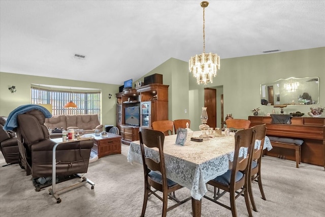 dining area featuring light colored carpet and a chandelier