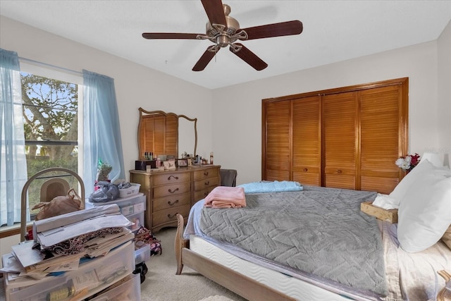 carpeted bedroom with a closet and ceiling fan