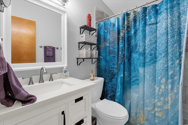 bathroom with vanity, toilet, and lofted ceiling