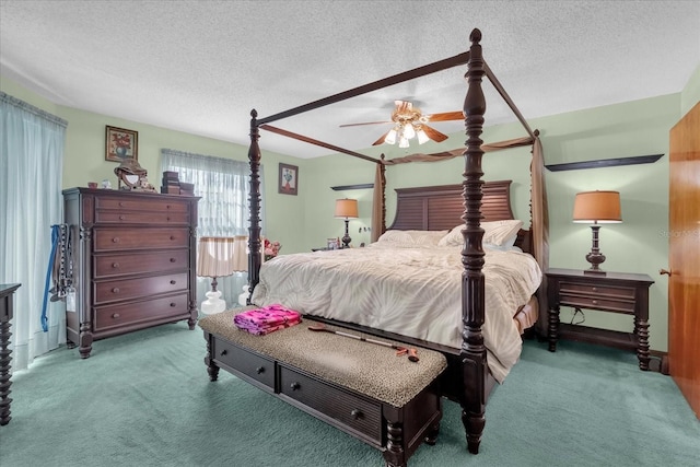 carpeted bedroom featuring a textured ceiling and ceiling fan