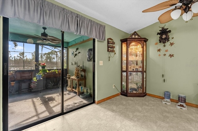 interior space featuring ceiling fan and lofted ceiling