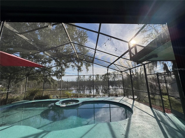 view of swimming pool with an in ground hot tub and glass enclosure