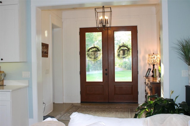 entrance foyer featuring a notable chandelier and french doors