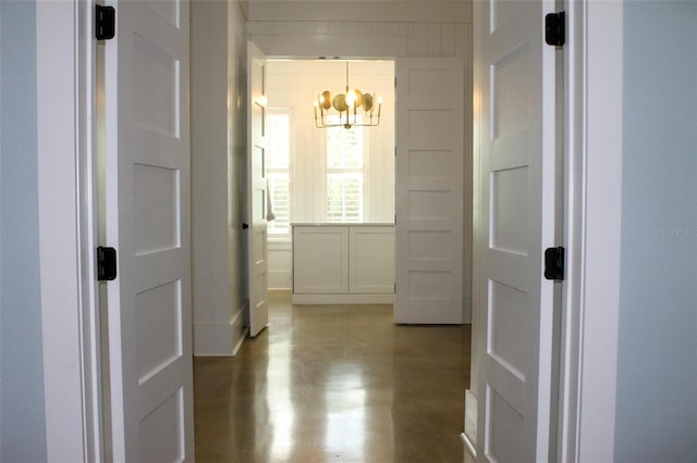 hall featuring a chandelier