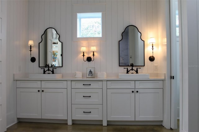 bathroom featuring vanity and wooden walls