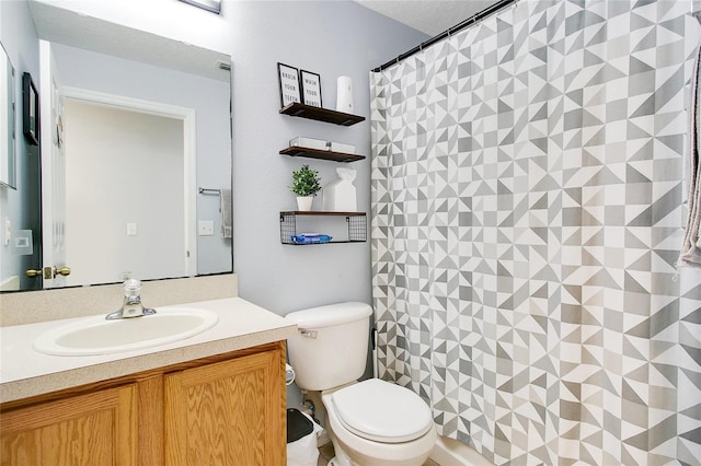 bathroom with walk in shower, vanity, and toilet