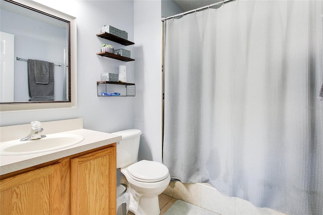 bathroom with tile patterned flooring, vanity, toilet, and walk in shower