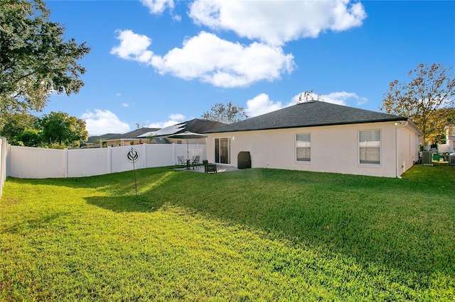 back of property featuring a yard and cooling unit