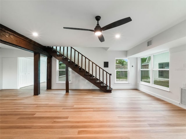 unfurnished living room with ceiling fan and light wood-type flooring