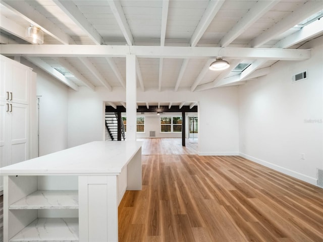 basement with light hardwood / wood-style flooring