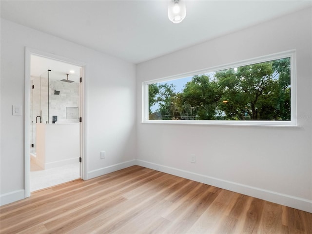 unfurnished bedroom with wood-type flooring and multiple windows