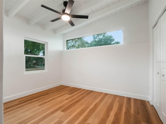 empty room with wood ceiling, ceiling fan, lofted ceiling with beams, and hardwood / wood-style flooring