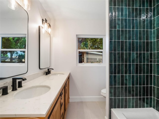 bathroom with tile patterned flooring, vanity, toilet, and a wealth of natural light