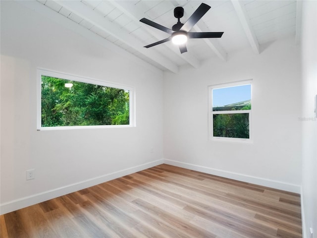 empty room featuring lofted ceiling with beams, light hardwood / wood-style floors, wooden ceiling, and ceiling fan