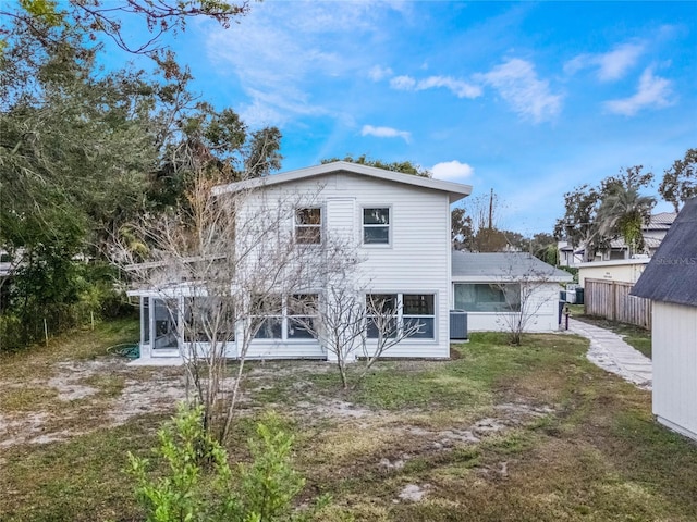 back of house featuring a yard, central AC, and a sunroom