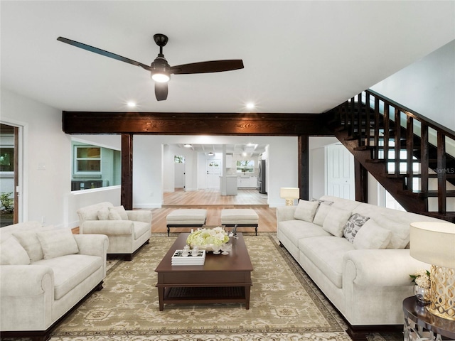 living room featuring ceiling fan, beamed ceiling, and hardwood / wood-style flooring