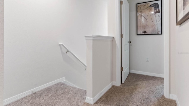 hallway featuring light colored carpet