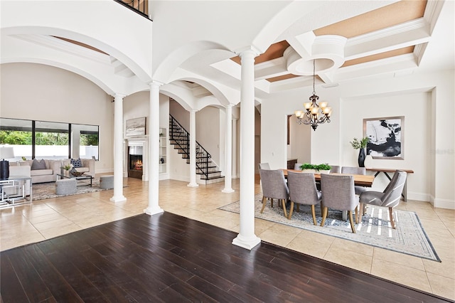 dining space with ornate columns, a chandelier, and ornamental molding