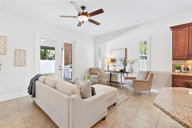 tiled living room featuring ceiling fan