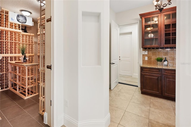 wine cellar featuring light tile patterned floors and a textured ceiling