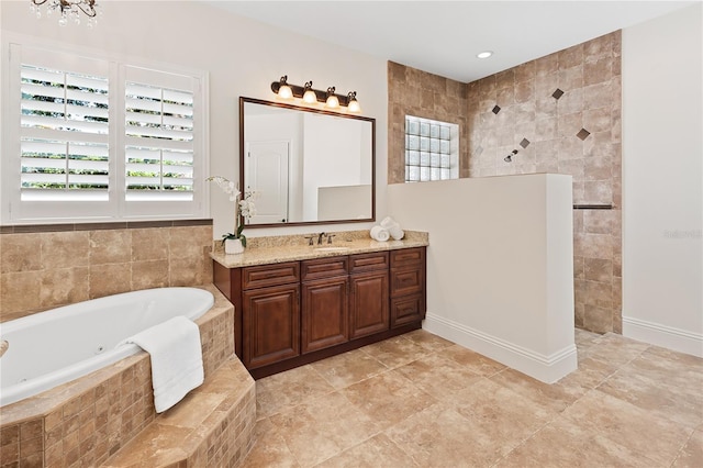 bathroom featuring vanity and tiled tub