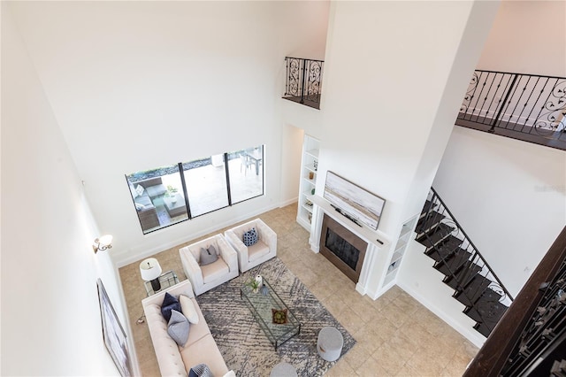 tiled living room featuring a high ceiling