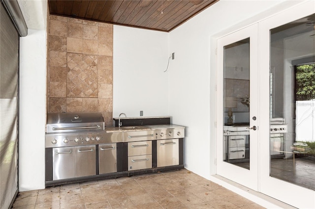 view of patio featuring area for grilling, french doors, an outdoor kitchen, and sink