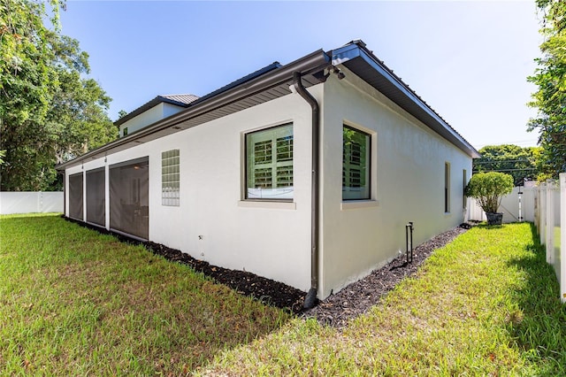 view of side of home with a lawn